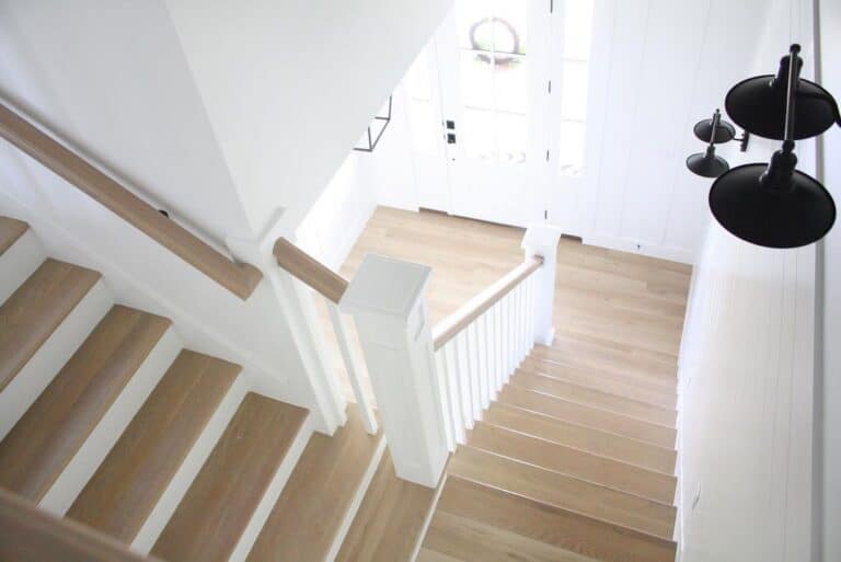 Wooden and White Stairs with Black Sconce Lighting