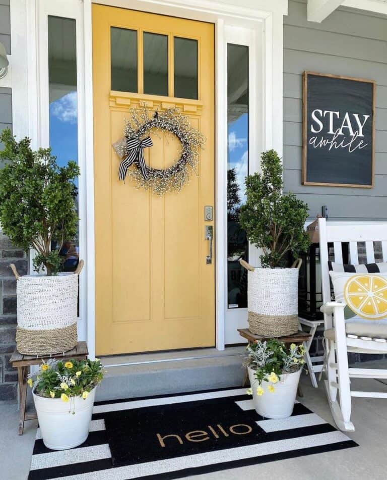 Yellow Front Door With Sidelights and a Rocking Chair