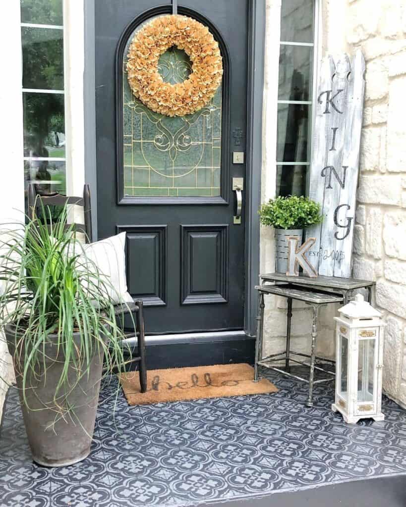 Yellow Wreath on a Black Front Door With Ornate Glass