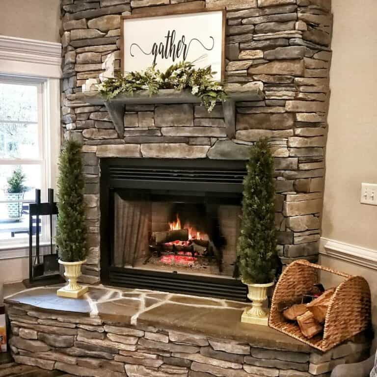 A White Sign and Green Foliage on a Wooden Mantel