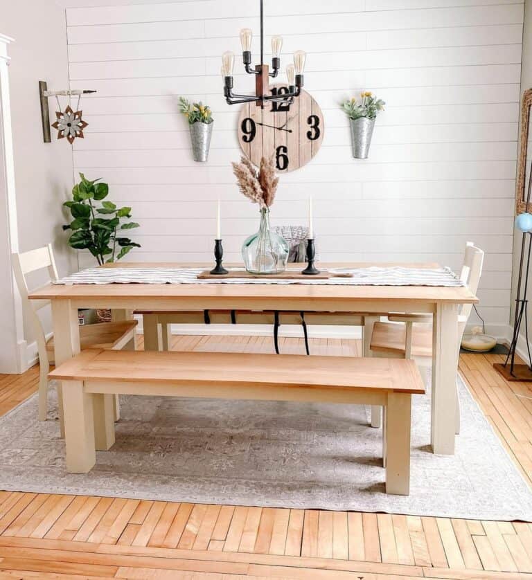 A Wooden Clock and Light Wood Dining Benches