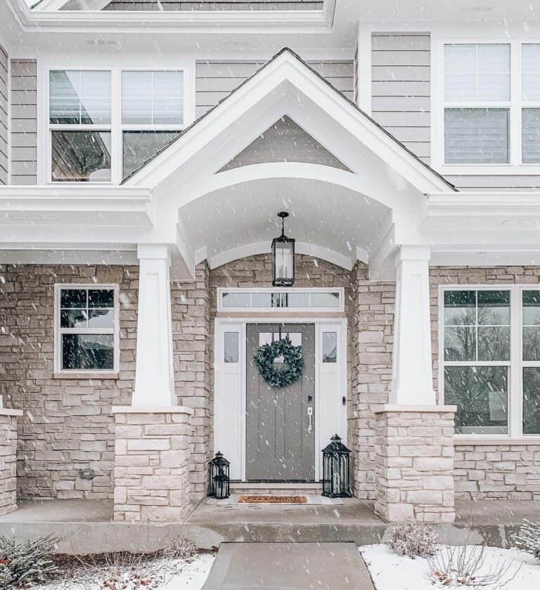 Beige Stone Home With Winter Door Decorations