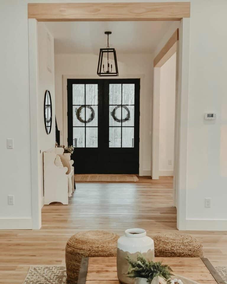 Black Front Doors Contrasting with Light Wood Entryway