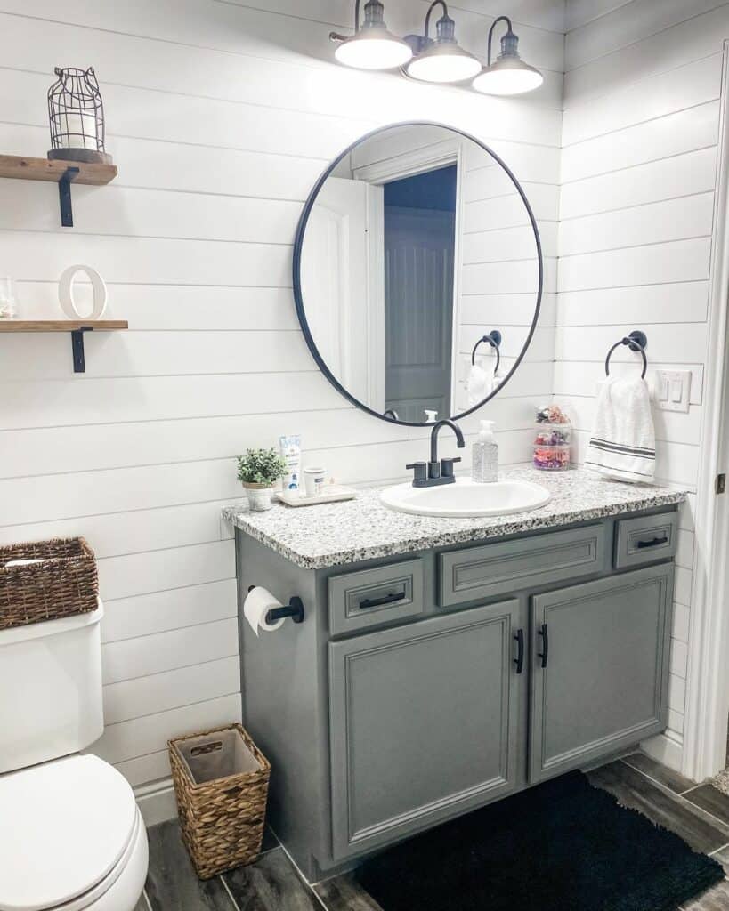 Black Lantern in a Bathroom With White Shiplap Walls