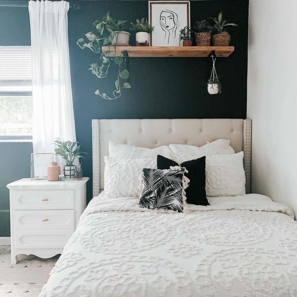 Black Wall Décor with Greenery and a Wood Shelf