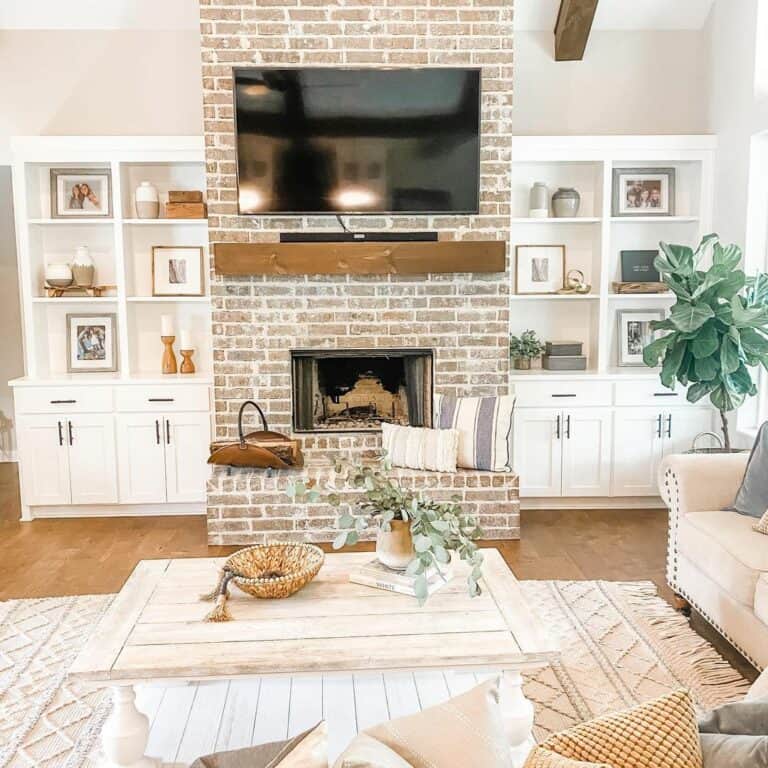 Brick Living Room Fireplace with White Built-In Shelving