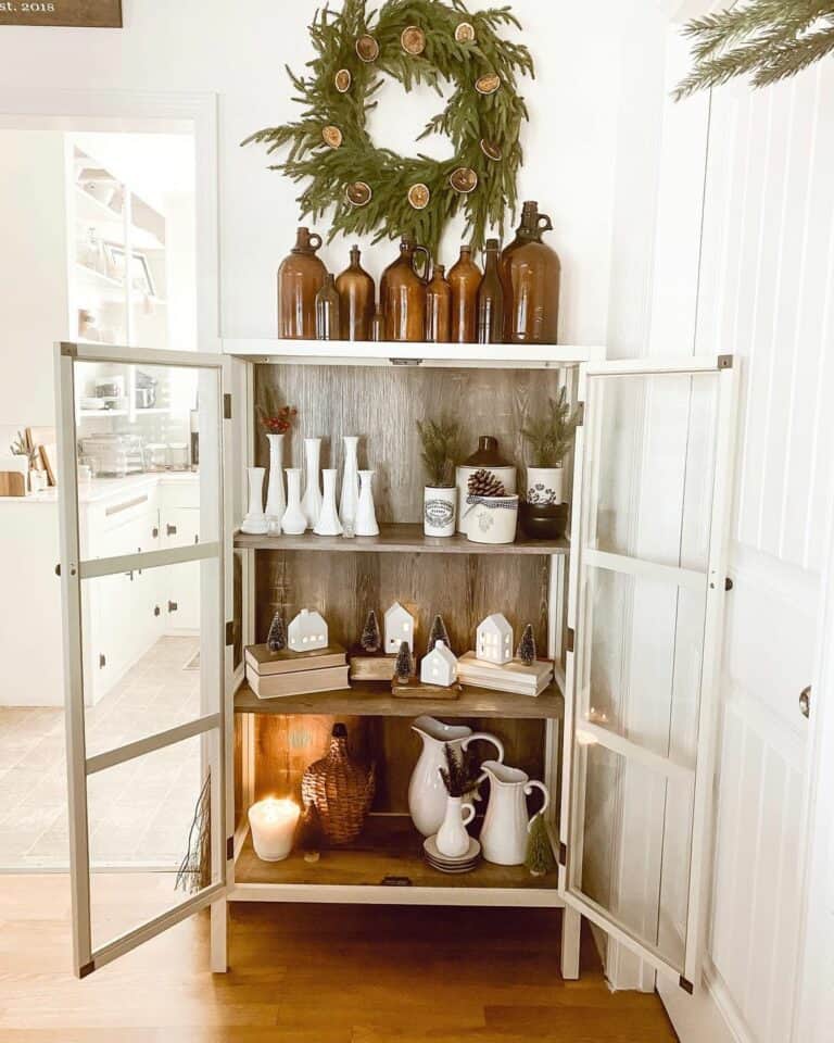 Dried Orange Christmas Wreath Decoration Above Farmhouse Cabinet