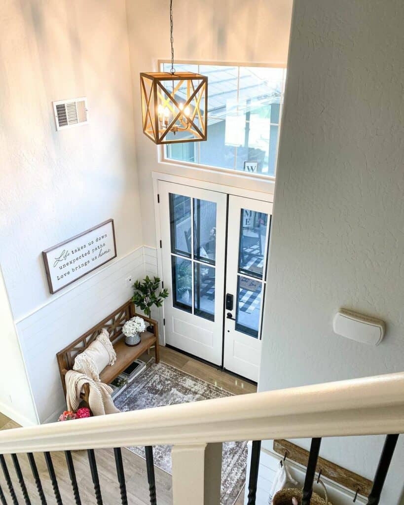 Entryway with Tall Ceilings and Geometric Pendant Light
