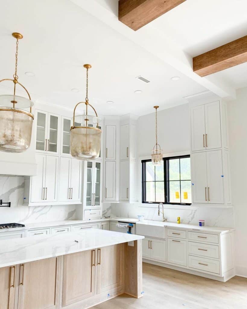 Glass and Gold Pendant Lights Over a White Oak Island