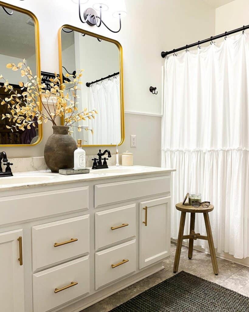Gold Mirrors and Light Gray Half Wall Paneling Bathroom