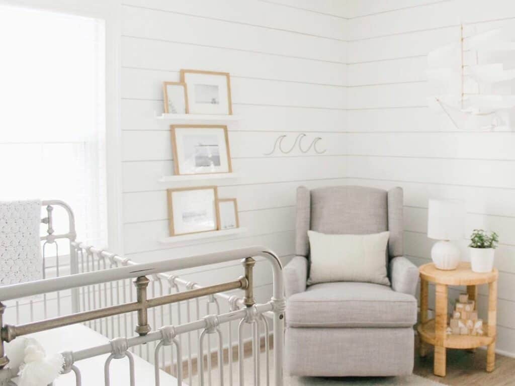 Gray Armchair in a White Shiplap Nursery