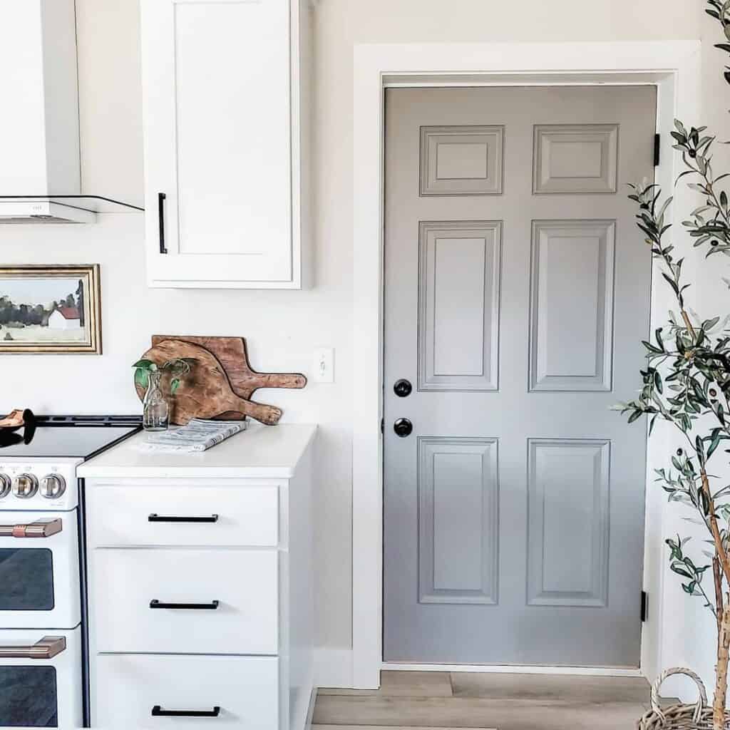 Gray Interior Door with White Trim in White Kitchen