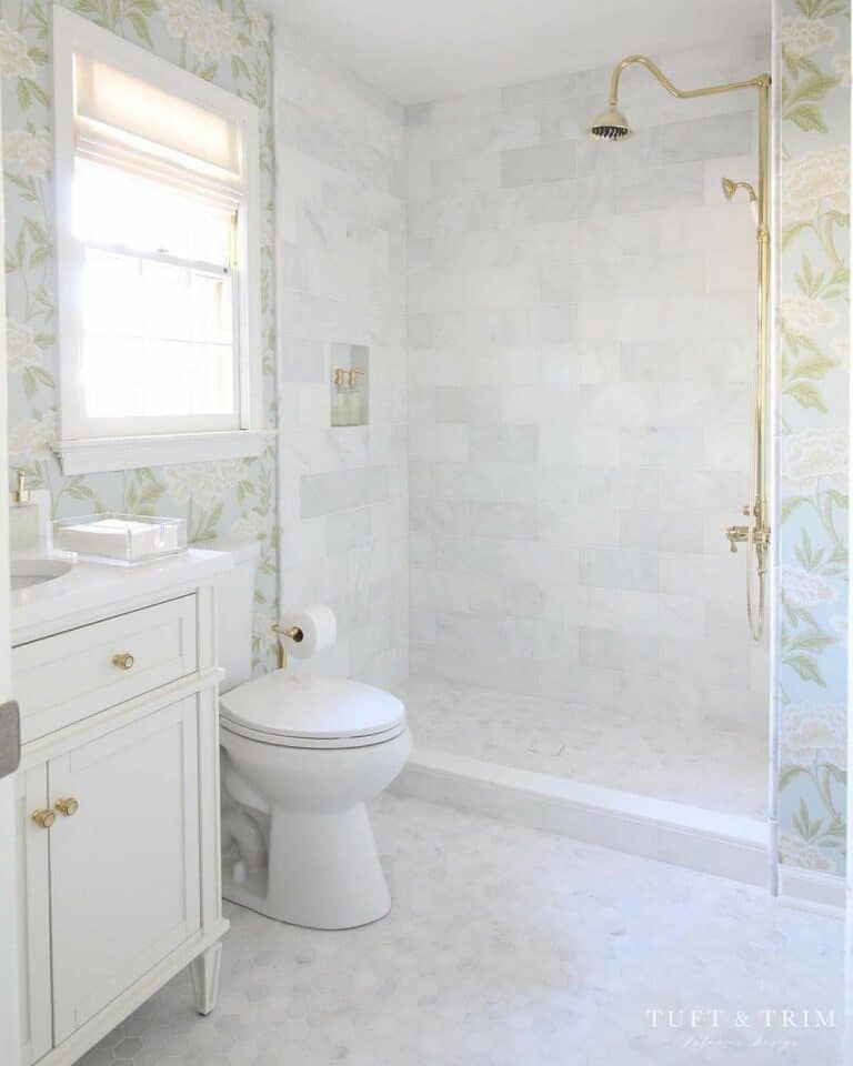 Gray and White Stone Tile Shower with Gold Shower Head
