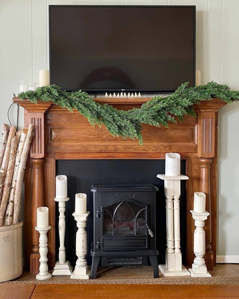 Green Garland and White Candles Winter Mantel Ideas