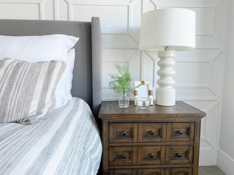 Intricate Accent Wall and Gray Wingback Headboard