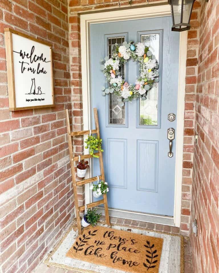 Light Blue Door with Plant Ladder and Wreath
