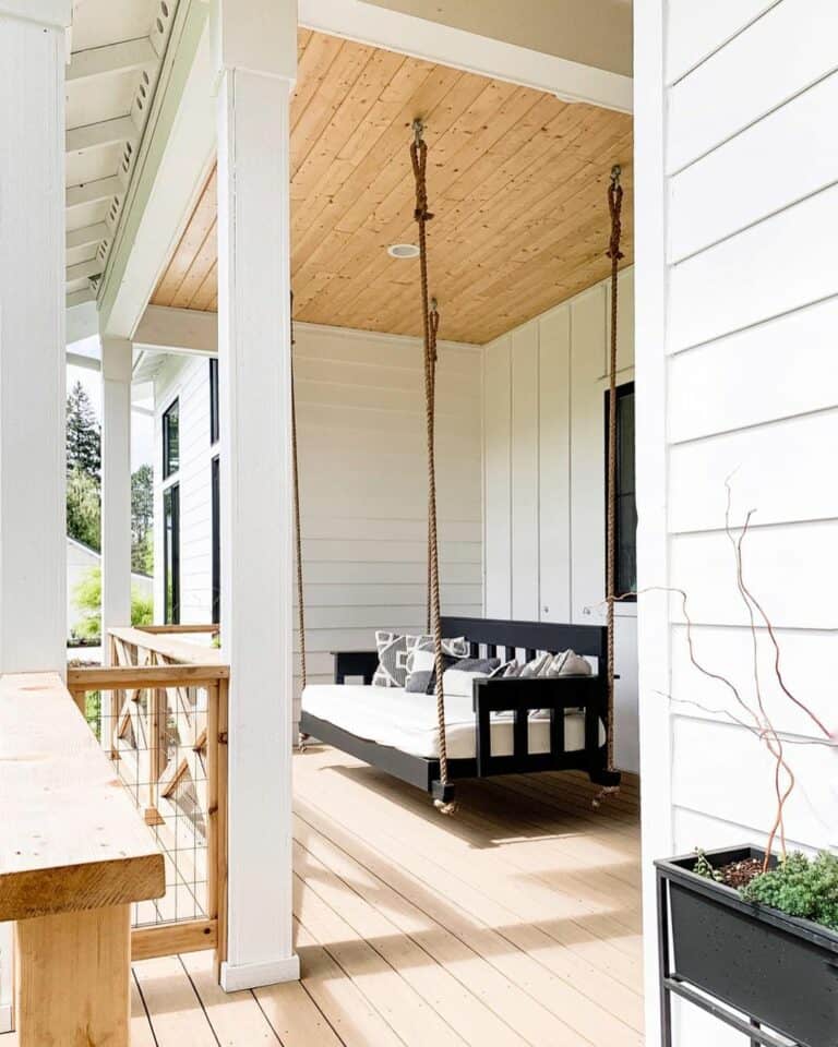 Light Wood Cable Railing and Black Porch Swing
