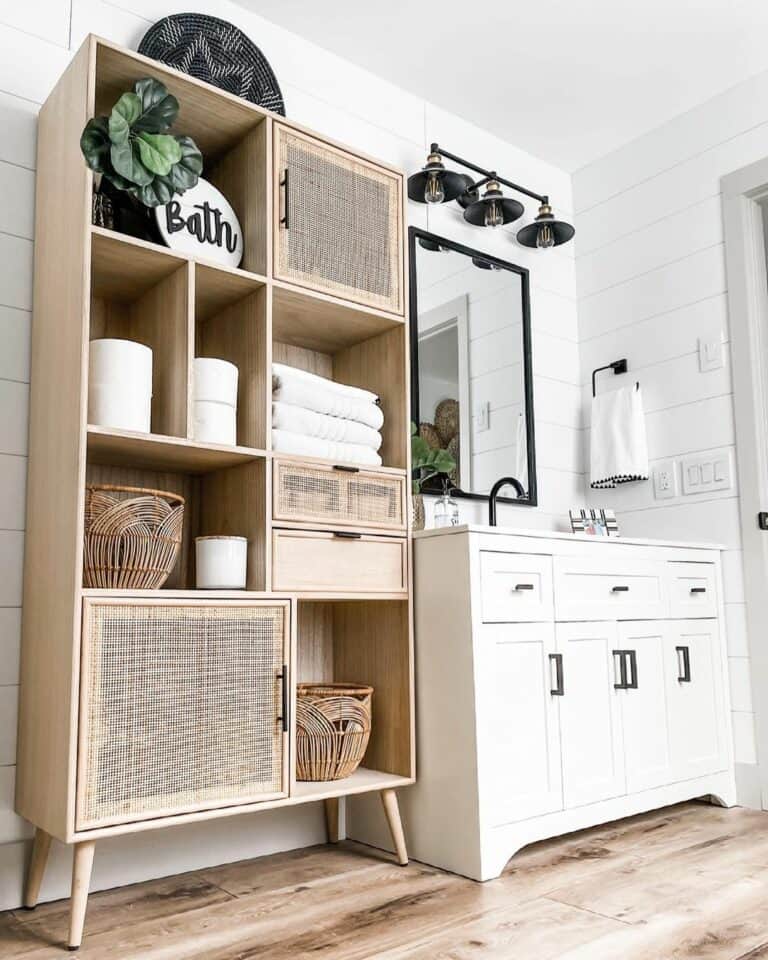 Light Wood Shelving Unit in a Black and White Bathroom