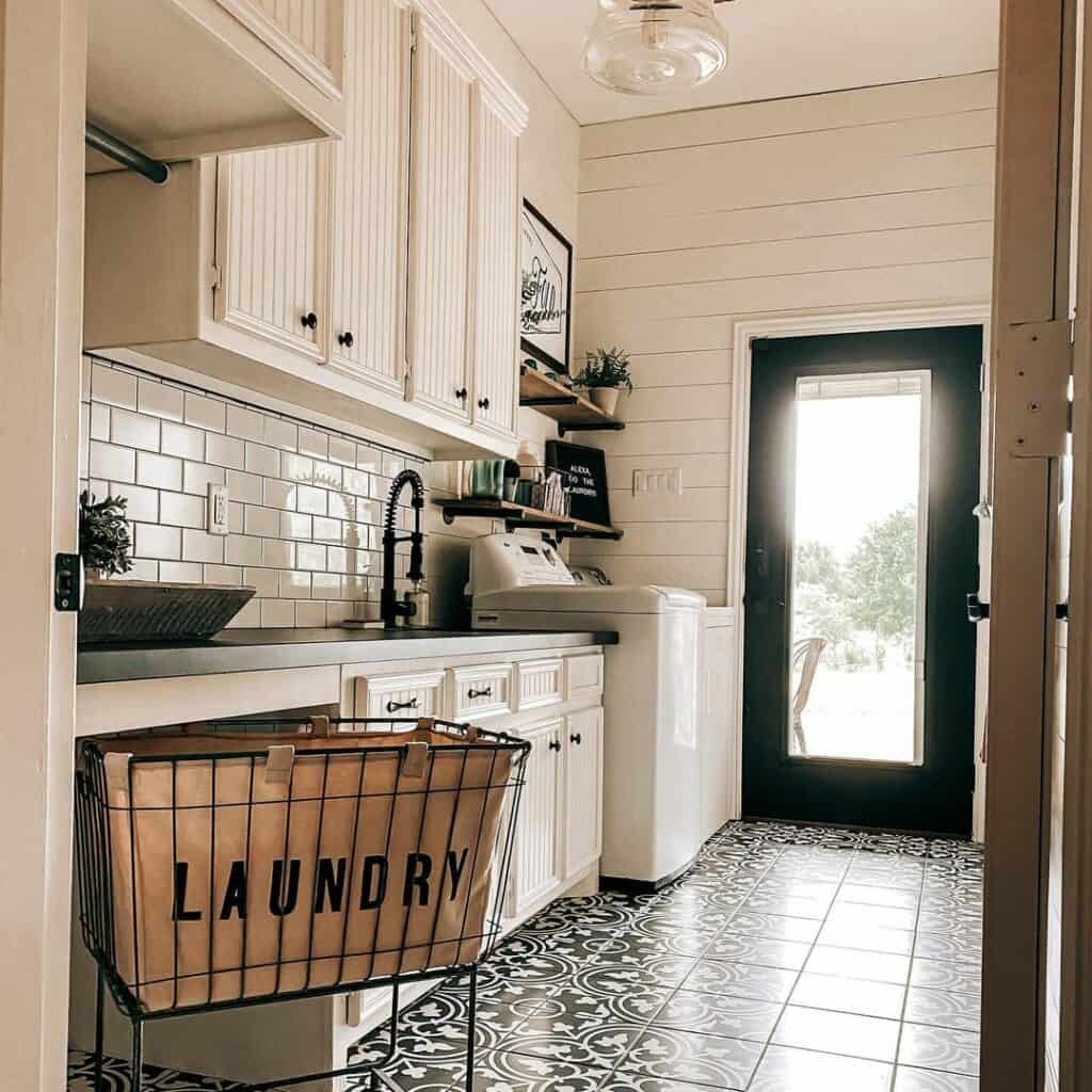 Metal Laundry Basket on an Ornate Black and White Tile Floor