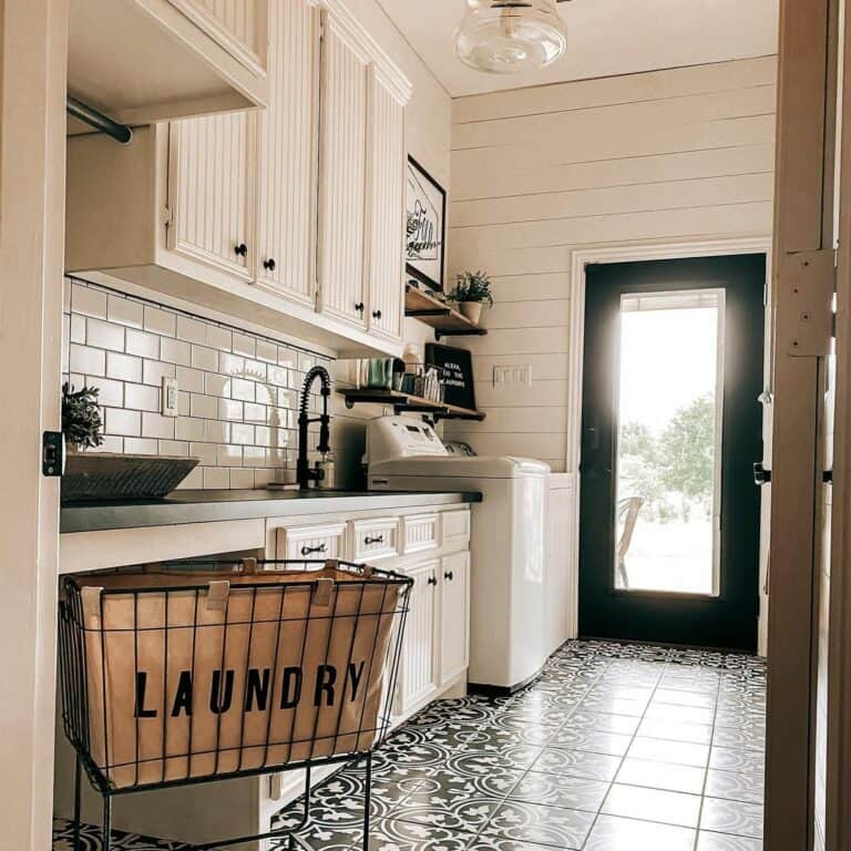 Metal Laundry Basket on an Ornate Black and White Tile Floor