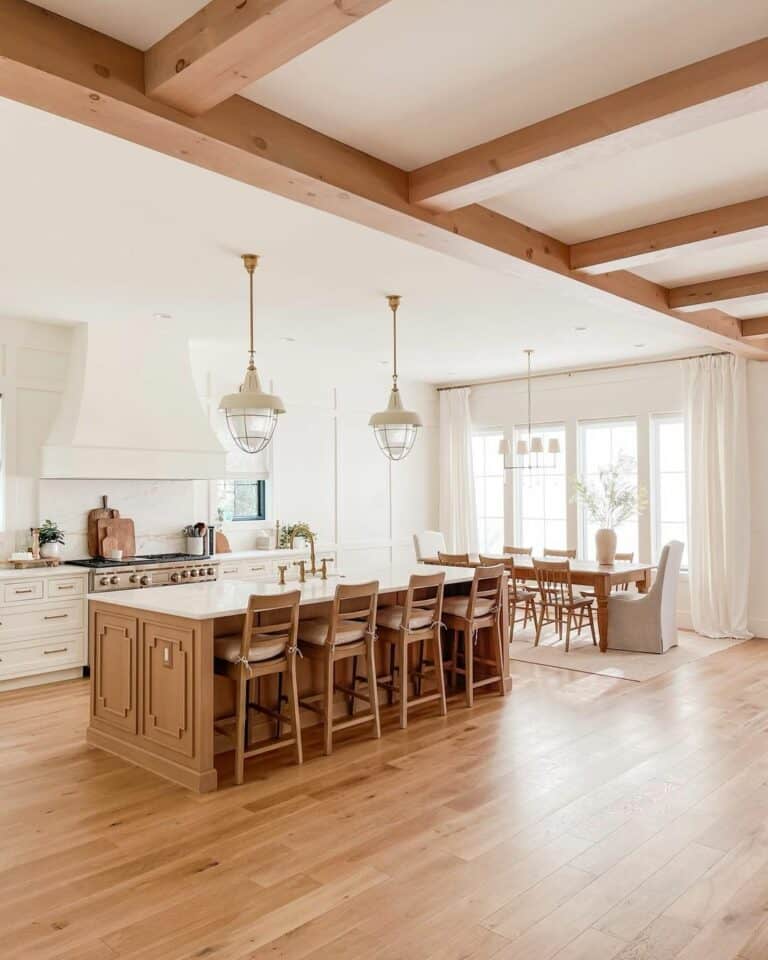Neutral Kitchen With Wood Beams and Stools