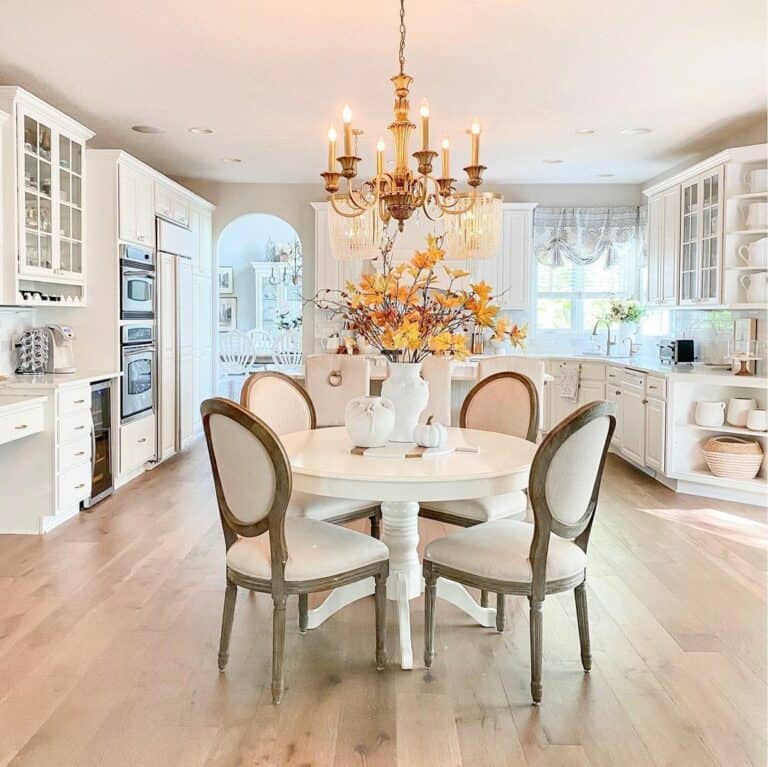 Open Concept Kitchen With Round White Dining Room Table