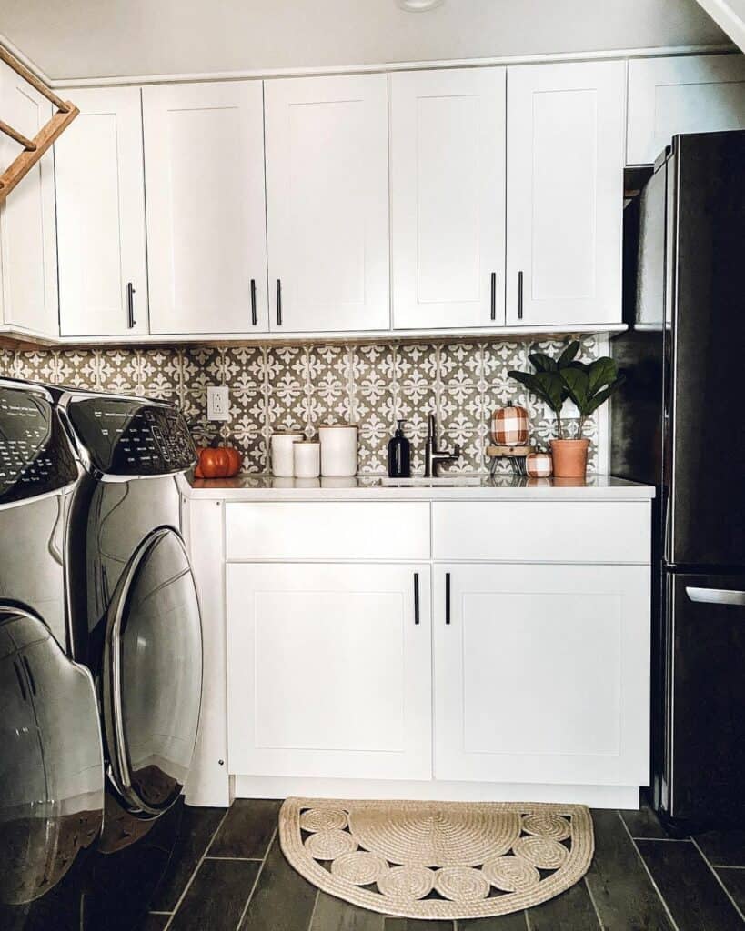 Orange Pumpkin Décor with a Decorative Brown Tile Backsplash