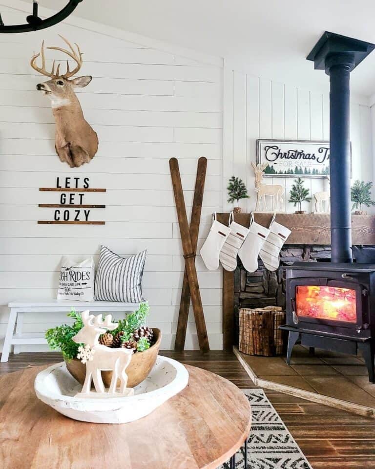 Pine Trees and Wooden Reindeer on a Wood Mantel
