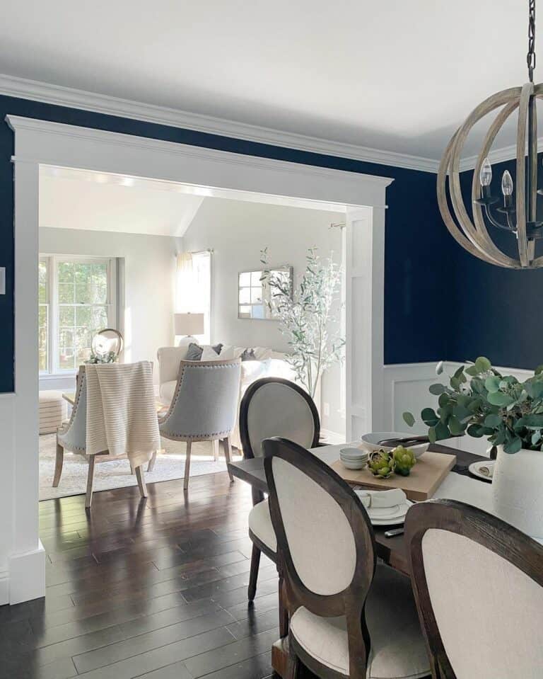 Spherical Chandelier and Dark Blue Walls with White Wainscoting