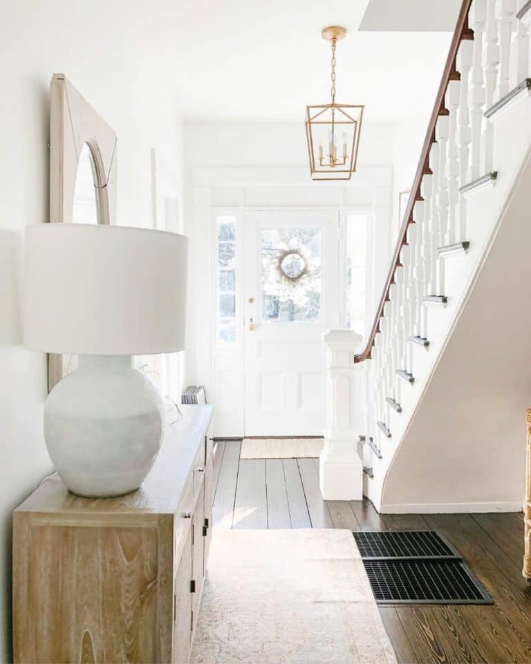 White Entryway with Gold Accent Lighting