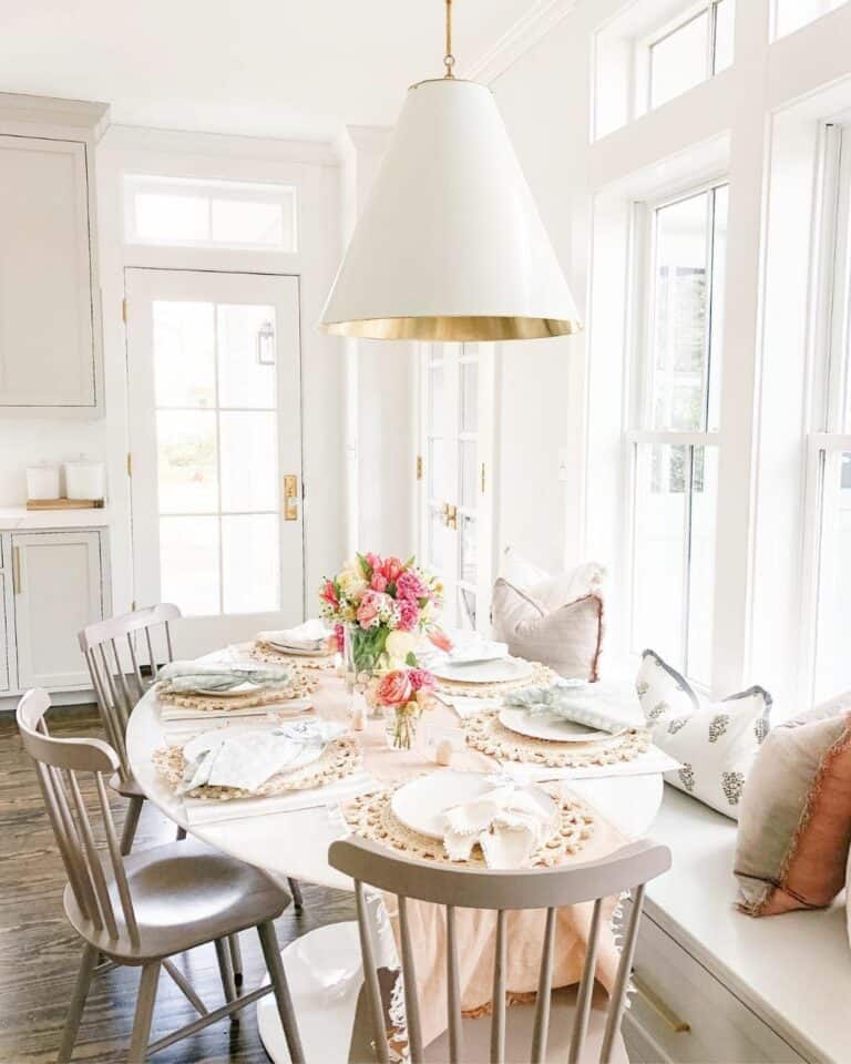 White Oval Dining Table with Pink Touches