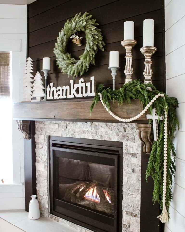 White Pine Trees and Candles Against a Black Shiplap Wall