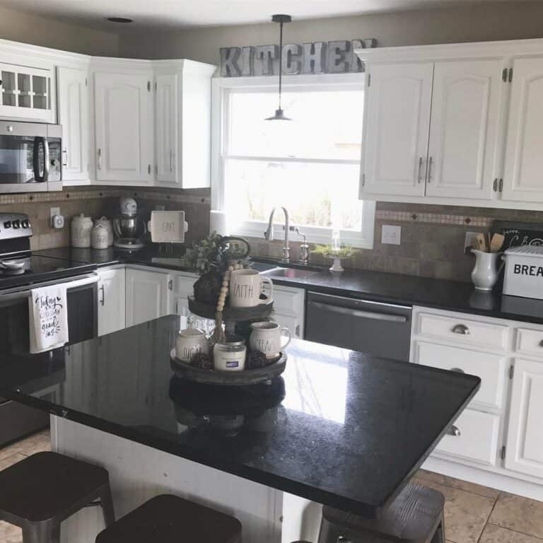 White Raised Panel Cabinets and Black Countertops