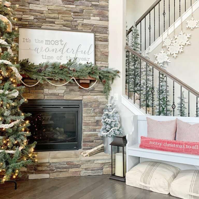 White Sign and Evergreen Garland on Stone Fireplace