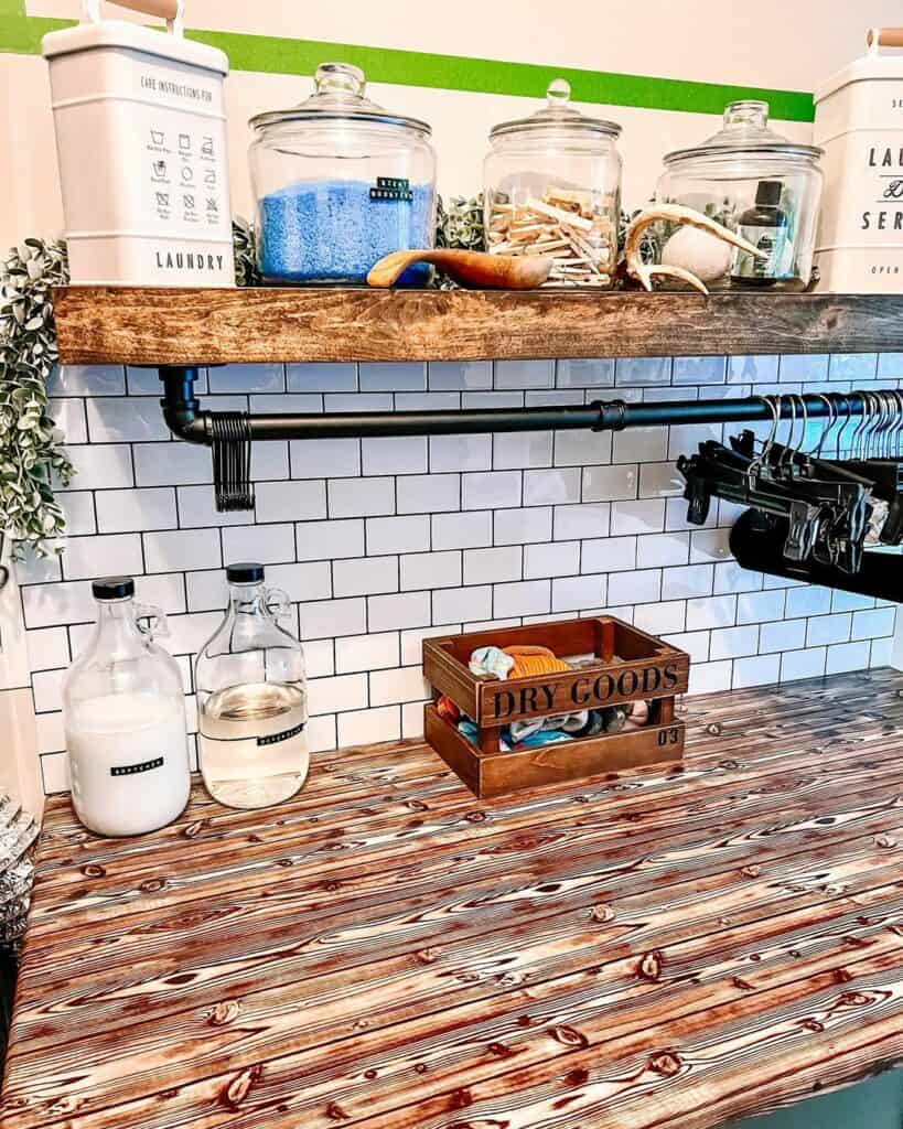 White Subway Tile Backsplash Behind an Industrial Black Pipe