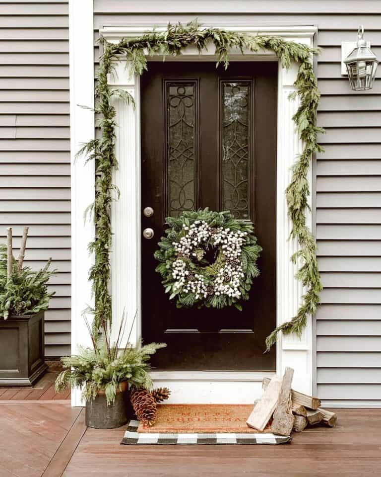 White Trim with Garland around Black Front Door