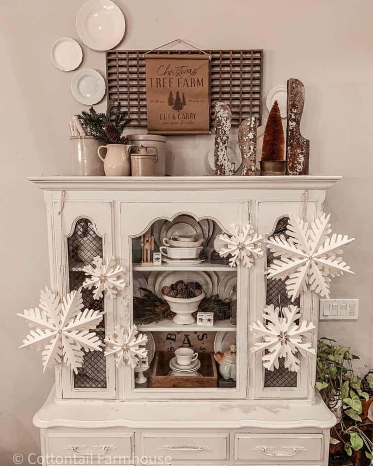 Antique Glass-Panel Hutch with Snowflake Decorations.