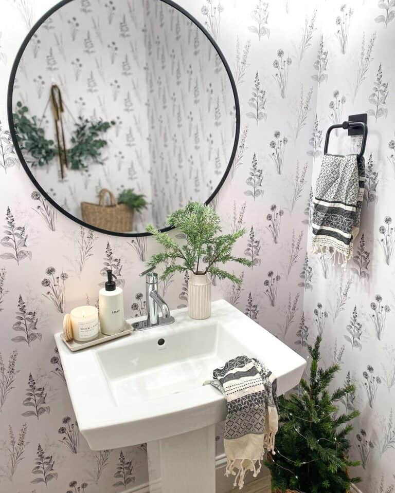 Bathroom With Round Mirror and Botanical Wallpaper