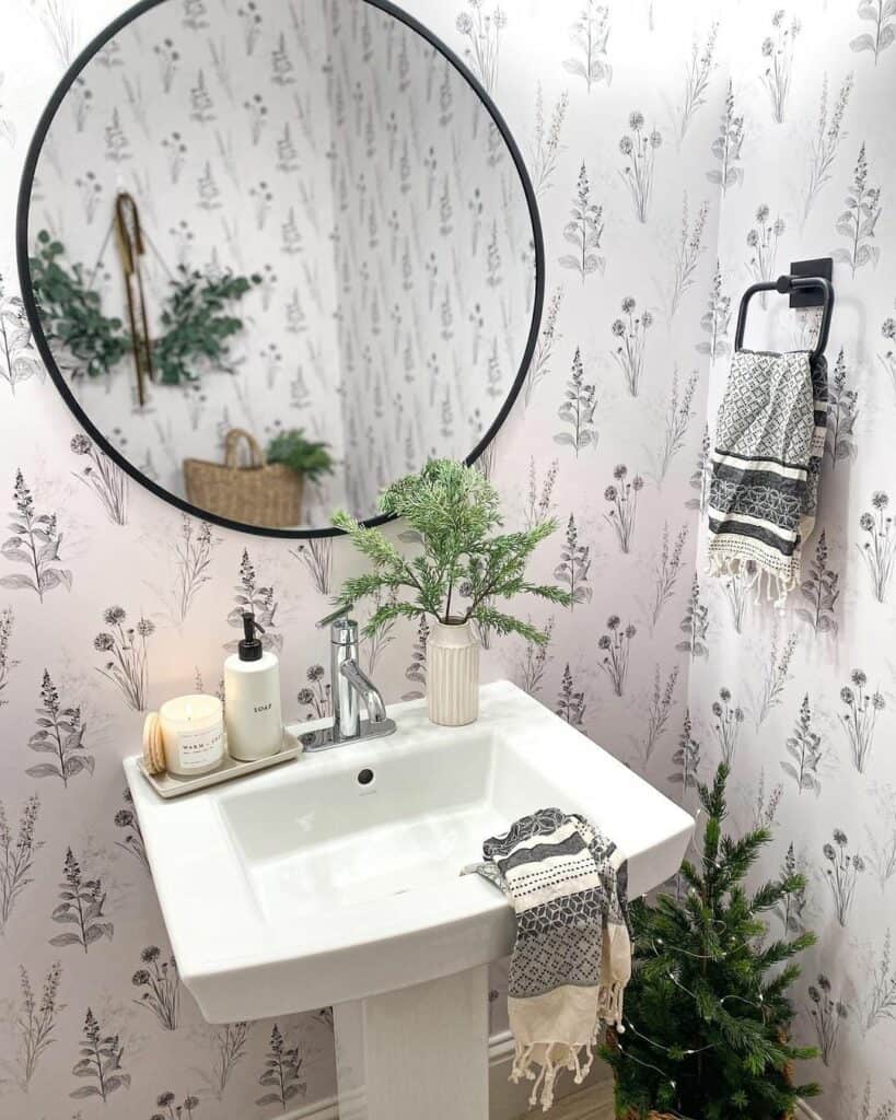 Bathroom With Round Mirror and Botanical Wallpaper