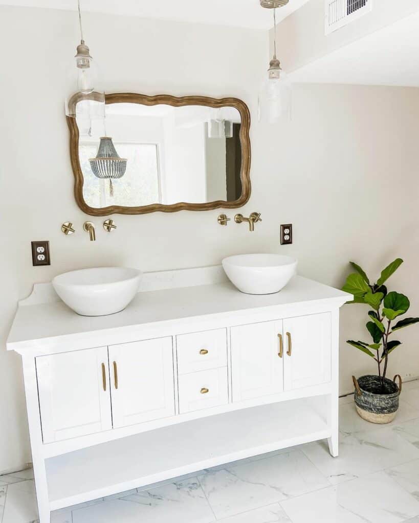 Bathroom with Gold Fixtures and Vintage Mirror
