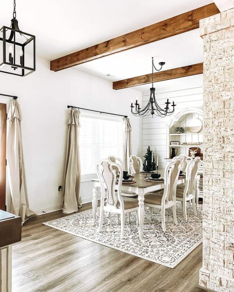 Black Chandelier Between Decorative Dark Wood Beams