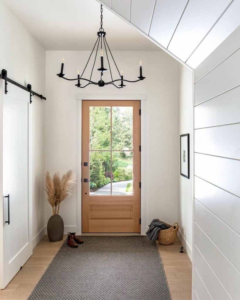 Black Chandelier Over Farmhouse Entryway