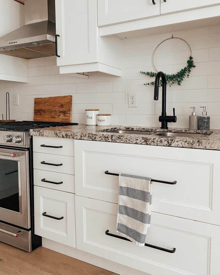 Black Hardware and Subway Tile Backsplash in a White Kitchen