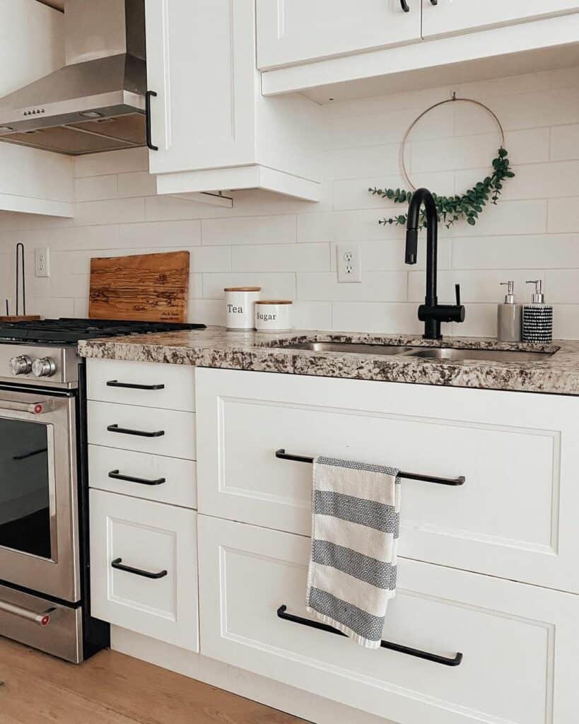 Black Hardware and Subway Tile Backsplash in a White Kitchen Soul & Lane