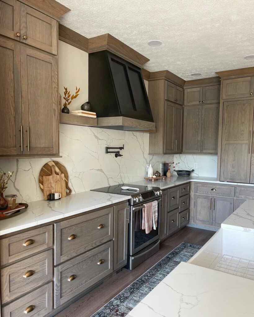 Black Range Hood and White Marble Backsplash