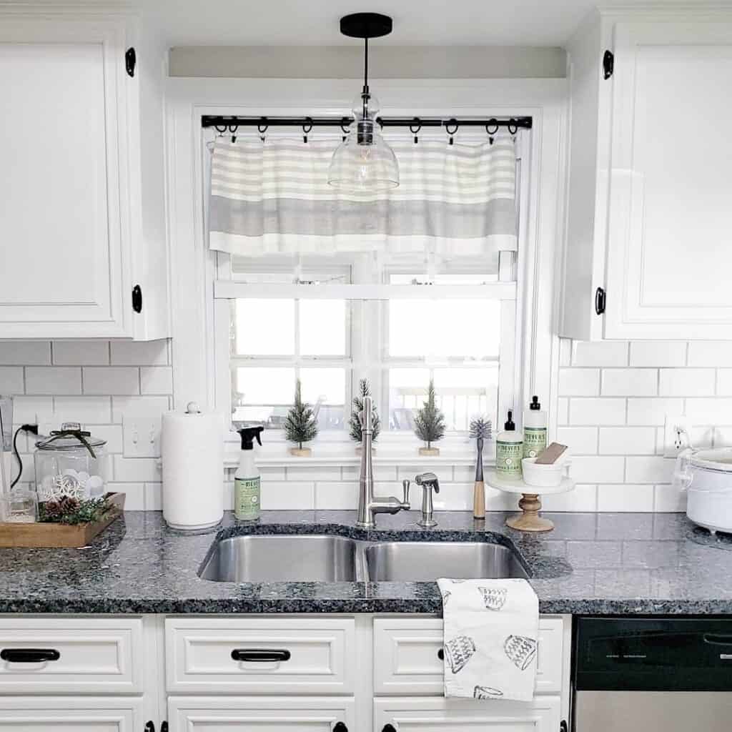 Black and White Kitchen With Gray-Striped Window Valance