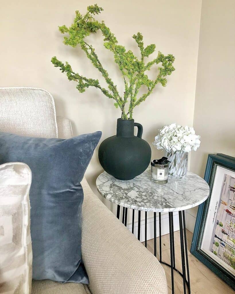 Blue and Gray Couch With Marbled End Table