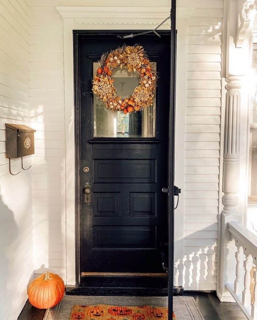 Brown and Orange Fall Wreath on a Black Door