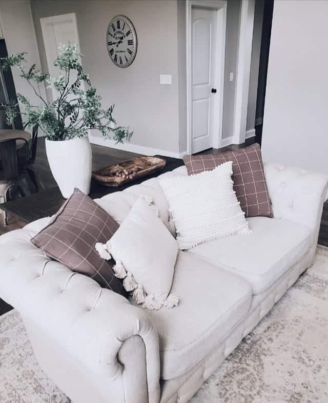 Checkered Brown Throw Pillows Behind White Throw Pillows