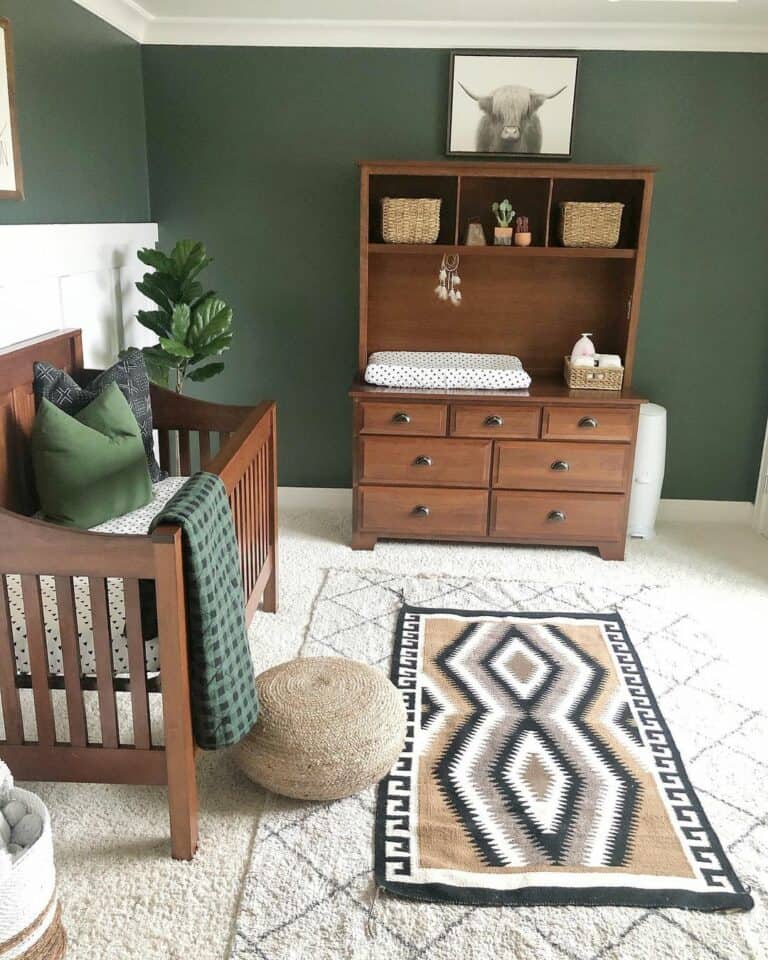 Dark Green Wall Nursery with Polished Wood Furniture